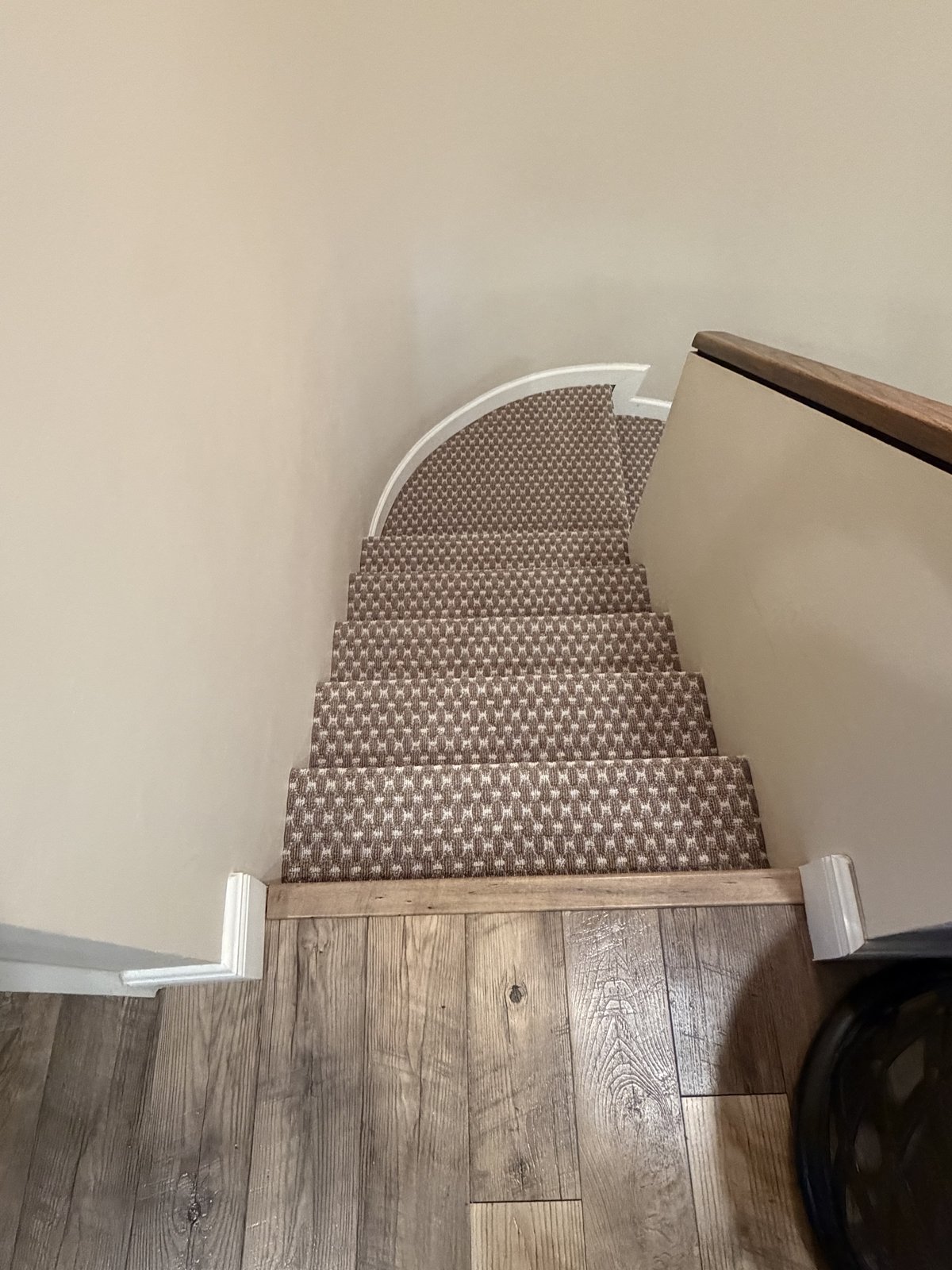 Curved stair runner with wood nosing, shot from above